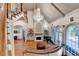 This living room features soaring ceilings, wooden floors, fireplace, and an abundance of natural light at 8455 Abingdon Ln, Duluth, GA 30097