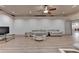 Expansive living room with light laminate flooring, recessed lights, and comfortable seating at 8455 Abingdon Ln, Duluth, GA 30097