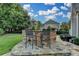 Outdoor kitchen features a stone bar and seating, perfect for enjoying the backyard view at 8455 Abingdon Ln, Duluth, GA 30097
