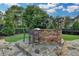 Outdoor kitchen with stone countertop and seating, perfect for entertaining and grilling poolside at 8455 Abingdon Ln, Duluth, GA 30097