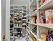 Walk-in pantry featuring rows of shelving, providing ample space for storage at 8455 Abingdon Ln, Duluth, GA 30097