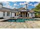 Beautiful pool with stone surround and covered patio, perfect for outdoor relaxation and entertainment at 8455 Abingdon Ln, Duluth, GA 30097