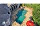 Aerial view of pool, patio, lounge chairs, and a red umbrella in a private backyard at 8455 Abingdon Ln, Duluth, GA 30097