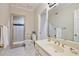 Well-lit bathroom featuring a glass-enclosed shower, tiled floors, and a stylish vanity area at 1111 Waterford Green Pt, Marietta, GA 30068