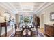 Formal dining room with coffered ceiling, chandelier, and large windows, perfect for gatherings at 1111 Waterford Green Pt, Marietta, GA 30068