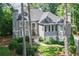 Stately home with a manicured lawn, mature trees, and a private driveway, offering a luxurious living experience at 1111 Waterford Green Pt, Marietta, GA 30068