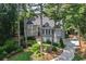 Elegant two-story home with a well-manicured lawn, lush landscaping, and mature trees at 1111 Waterford Green Pt, Marietta, GA 30068