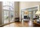 Sunlit foyer featuring a decorative glass door, hardwood flooring, and a fireplace in the adjacent living area at 1111 Waterford Green Pt, Marietta, GA 30068