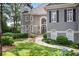 This home features a manicured lawn, a stone walkway, and lush landscaping at 1111 Waterford Green Pt, Marietta, GA 30068