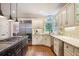 Bright kitchen with granite countertops, stainless steel appliances and wood floors at 1111 Waterford Green Pt, Marietta, GA 30068