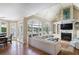Bright living room with vaulted ceiling, built-ins, fireplace, and large windows overlooking the yard at 1111 Waterford Green Pt, Marietta, GA 30068