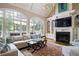 Cozy living room with a fireplace, built-in bookshelves, and large windows offering a view at 1111 Waterford Green Pt, Marietta, GA 30068