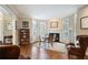 Cozy living area featuring a fireplace, shuttered windows, hardwood floors and comfortable seating at 1111 Waterford Green Pt, Marietta, GA 30068