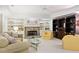 Inviting living room featuring a stone fireplace, built-in shelving, plush seating, and ample natural light at 1111 Waterford Green Pt, Marietta, GA 30068