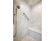 Modern shower featuring marble tile, a built-in seat, and a rainfall shower head at 1111 Waterford Green Pt, Marietta, GA 30068