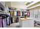 Spacious walk-in closet with custom shelving, storage island, and natural light from the window at 1111 Waterford Green Pt, Marietta, GA 30068