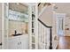 Compact and stylish wet bar area located next to the carpeted staircase at 1111 Waterford Green Pt, Marietta, GA 30068