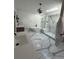 Bright bathroom with a soaking tub, glass shower and marble-patterned flooring at 125 Sir Lancelot Ct, Fayetteville, GA 30214
