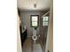Compact bathroom with a shower, toilet and vanity with patterned wallpaper at 125 Sir Lancelot Ct, Fayetteville, GA 30214