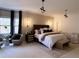 Serene bedroom with neutral tones, a king-size bed and custom lighting at 125 Sir Lancelot Ct, Fayetteville, GA 30214