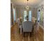 Elegant dining room with a large table, seating for ten, and stylish geometric patterned wallpaper at 125 Sir Lancelot Ct, Fayetteville, GA 30214