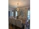 Bright dining room with stylish geometric wallpaper, large table, and comfortable seating for ten at 125 Sir Lancelot Ct, Fayetteville, GA 30214