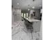 Spacious kitchen with marble floors, large island with seating, and stylish pendant lighting at 125 Sir Lancelot Ct, Fayetteville, GA 30214