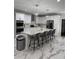 Bright and airy kitchen with modern white cabinets, stainless appliances, and marble island with seating at 125 Sir Lancelot Ct, Fayetteville, GA 30214