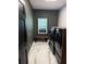 Modern laundry room with dark green walls and a front-load washer and dryer at 125 Sir Lancelot Ct, Fayetteville, GA 30214