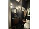 Stylish powder room boasting black walls, gold accents, and modern fixtures at 125 Sir Lancelot Ct, Fayetteville, GA 30214
