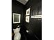 Chic powder room with bold black decor, statement mirror, and 'Powder Room' sign at 125 Sir Lancelot Ct, Fayetteville, GA 30214