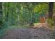 Lush backyard with wooded area and stairs leading up to the deck at 3860 Paint Cir, Douglasville, GA 30135