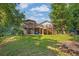 Spacious backyard featuring a wooden deck, lush greenery, and peaceful surroundings at 3860 Paint Cir, Douglasville, GA 30135
