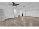 Large basement with wood-look flooring, white walls, and modern ceiling fan at 3860 Paint Cir, Douglasville, GA 30135