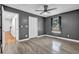A well-lit bedroom featuring a ceiling fan and modern gray walls at 3860 Paint Cir, Douglasville, GA 30135