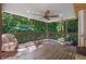 Covered wooden deck offers a relaxing space with ceiling fan and comfortable seating at 3860 Paint Cir, Douglasville, GA 30135