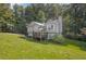 Inviting two-story home with a gray exterior, charming front porch, and a lush green lawn at 3860 Paint Cir, Douglasville, GA 30135