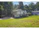 Two-story home with gray siding, a covered front porch, and a driveway leading to an attached garage at 3860 Paint Cir, Douglasville, GA 30135