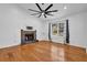 Bright living room with hardwood floors, a stone fireplace, and a large window with stylish curtains at 3860 Paint Cir, Douglasville, GA 30135