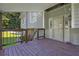 Covered porch with wood decking, sliding door, and railing at 3860 Paint Cir, Douglasville, GA 30135