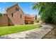 Brick home exterior featuring a manicured lawn, and second story patio at 2012 Arbor Springs Way, Buford, GA 30519