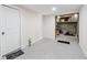 Unfinished basement with painted floor, white door and open utility area with exposed pipes at 2012 Arbor Springs Way, Buford, GA 30519