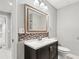 Bathroom featuring a vanity, mirror, and toilet at 2012 Arbor Springs Way, Buford, GA 30519