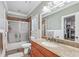 Well-lit bathroom showcasing granite countertops, tiled shower, and ample storage space at 2012 Arbor Springs Way, Buford, GA 30519