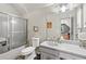 Bathroom with shower/tub combo, large mirror, and bright neutral paint at 2012 Arbor Springs Way, Buford, GA 30519