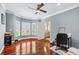 Bright bedroom with bay windows, hardwood floors, ceiling fan, and easy access to the bathroom at 2012 Arbor Springs Way, Buford, GA 30519