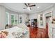 Serene bedroom with hardwood floors, bay windows, and a ceiling fan for added comfort at 2012 Arbor Springs Way, Buford, GA 30519