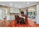 Bright dining area featuring hardwood floors, built-in cabinetry, and a view of the living room at 2012 Arbor Springs Way, Buford, GA 30519