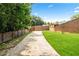 Long driveway leading to the house, bordered by trees and a wooden fence at 2012 Arbor Springs Way, Buford, GA 30519