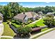 Attractive home with a lush lawn, mature landscaping, and a stone retaining wall in a suburban setting at 2012 Arbor Springs Way, Buford, GA 30519